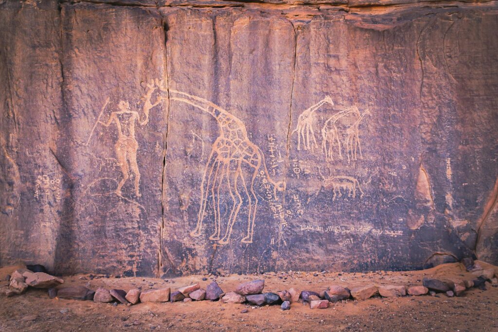 Photo by Djamel Ramdani: https://www.pexels.com/photo/an-ancient-wall-carving-on-brown-stone-wall-9180227/